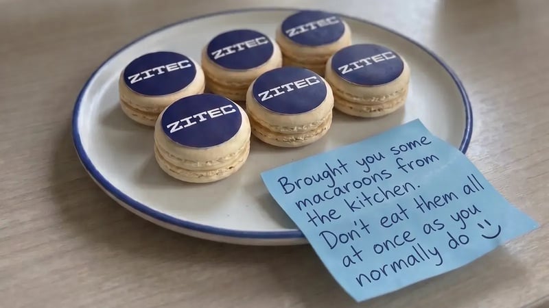 Zitec-branded macarons with a playful handwritten note from the team kitchen